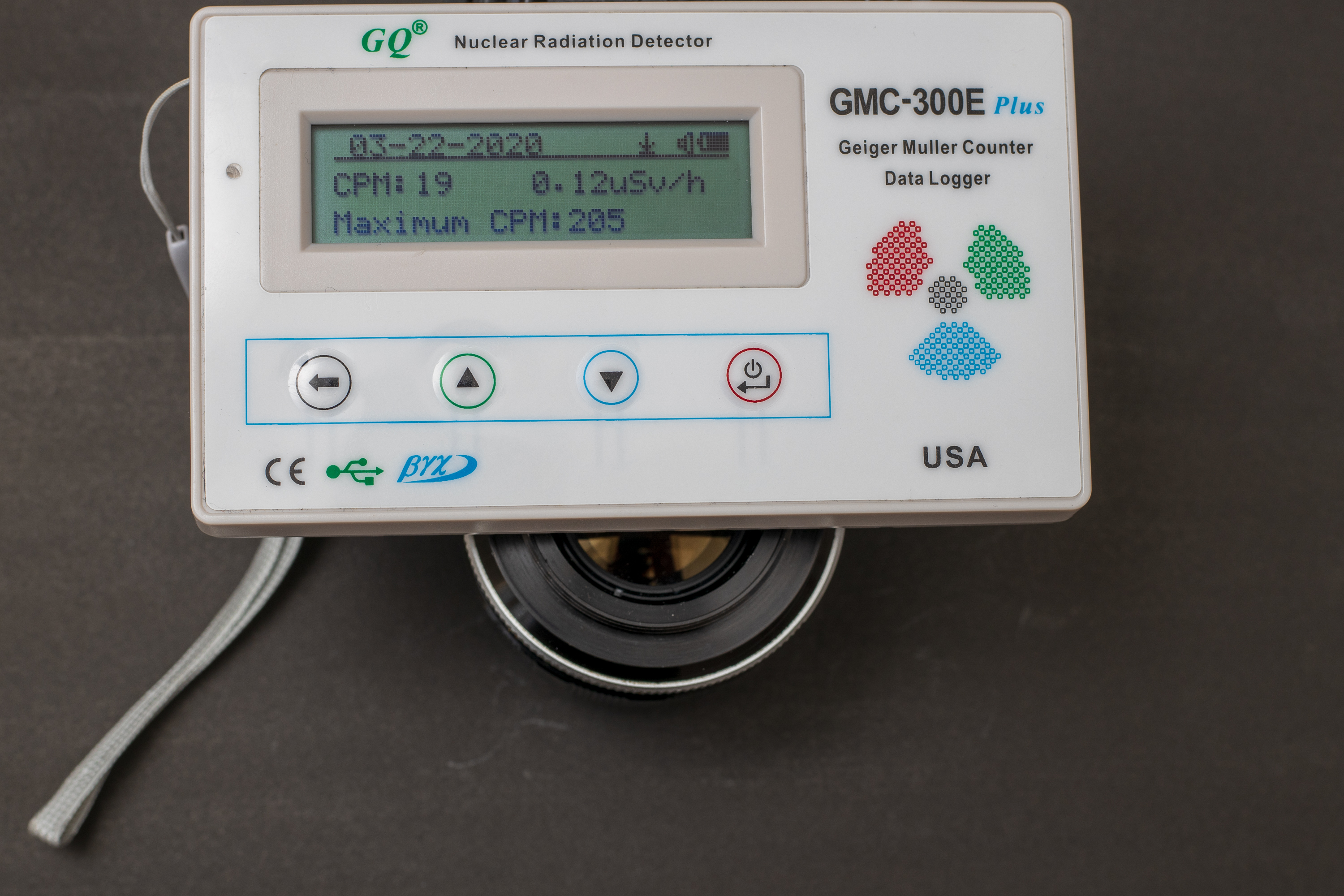 Geiger counter registering 0.12 uSv/h for the rear of the lens, just 0.02 uSv higher than the background.